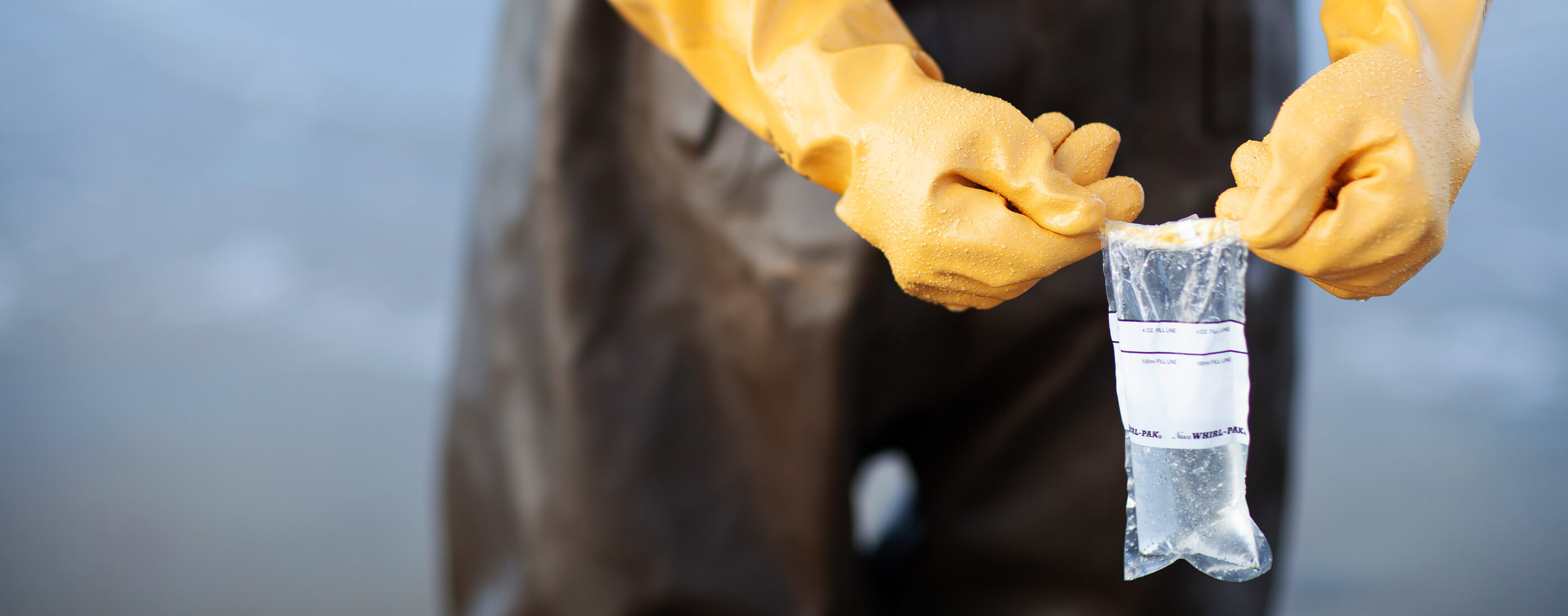 Person-wearing-gloves-tests-water-quality